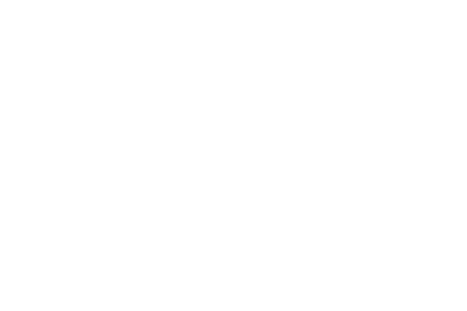 A reading desk at night with an open notebook and a lamp.