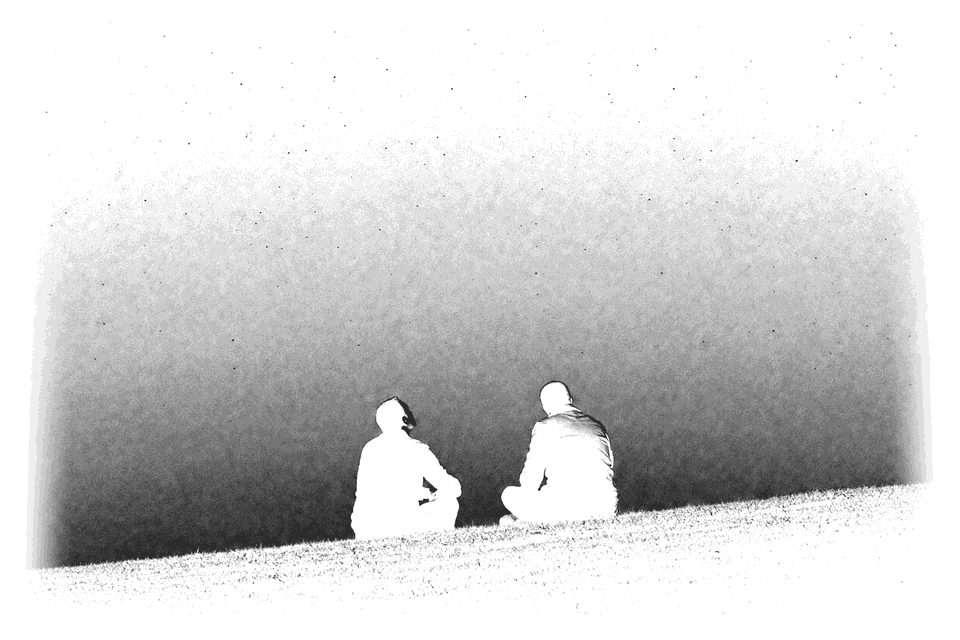 Two people seated, seen from behind, the night sky between them.